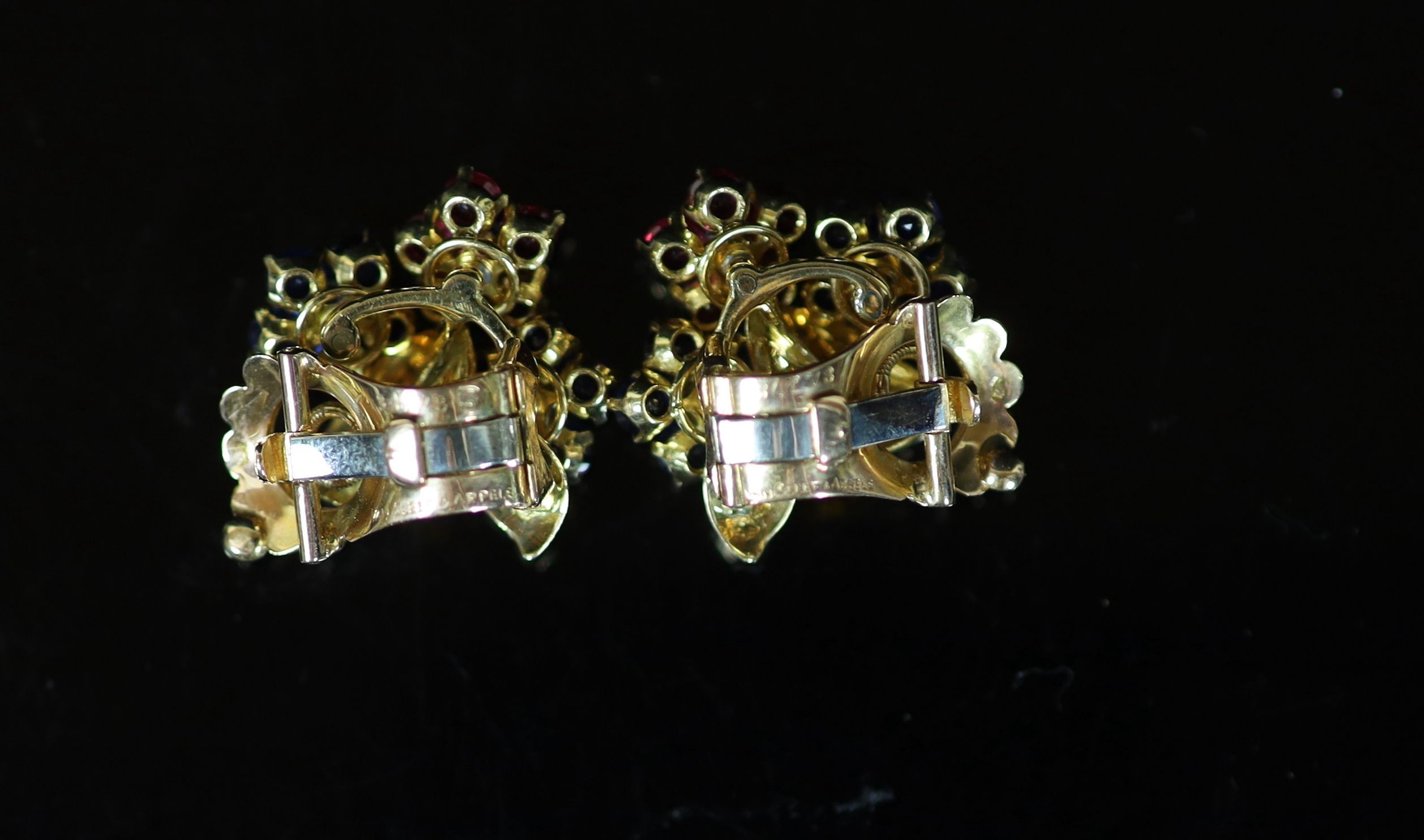 A pair of French Van Cleef & Arpels 18ct gold, ruby, diamond and sapphire set triple flower head cluster ear clips